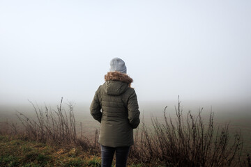 Lost person in fog. Lonely woman in empty misty landscape - Powered by Adobe