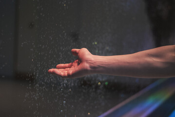 Hand in water drops