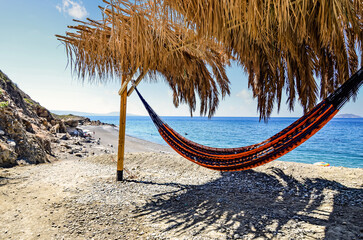 Little corner of paradise with a hammock in the shade facing the sea
