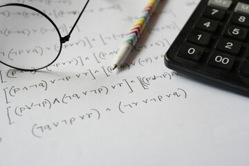 Hand writing algebra equations on a paper 
