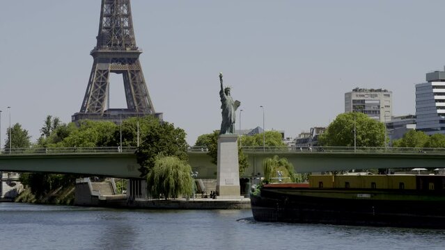 The Statue of Liberty in Paris and the Eiffel Tower, France.