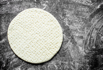 Preparation pizza. Rolled out dough for homemade pizza.