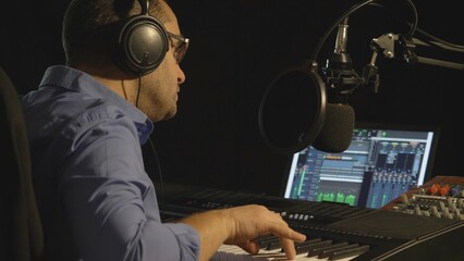 Portrait of young singer play at piano producing music