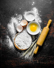 Flour with egg and a rolling pin.