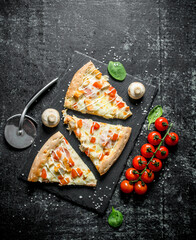 Chicken pizza slices and cherry tomatoes.