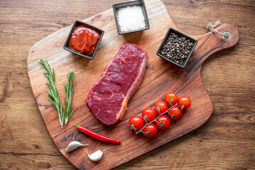 raw beef steak on wooden background