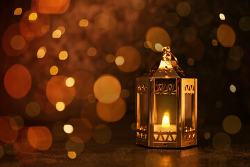 Muslim lantern with glowing candle on dark background with space for text. Ramadan celebration © Pixel-Shot