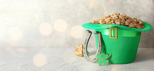 Green hat with leprechaun's gold, horseshoe and clover on grunge background with space for text....
