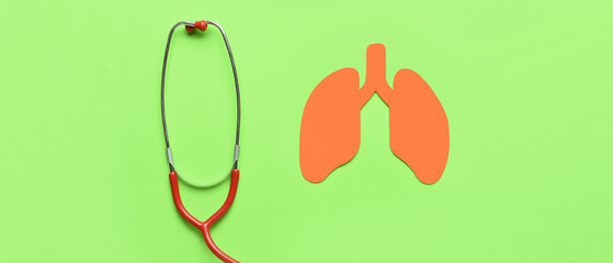 Paper lungs and stethoscope on green background