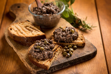 italian canape with liver pate over wood table