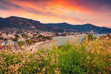 Incredible summer scene of Paleo Tsifliki village. Blooming flowers on the shore of Aegean Sea at...