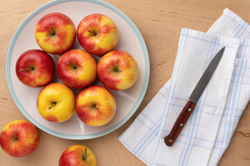 ripe apples close-up in a bowl on a wooden background