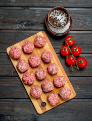 Raw meat meatballs with spices .