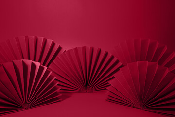 Viva magenta abstract background with hand paper fan for product minimal presentation