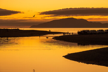 Otaki river mouth sunset, with families and folks enjoying the last of the day