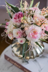 Bouquet with roses, hydrangea. Stabilized flowers in a white ceramic vase at home on the dressing table. Interior decor.
