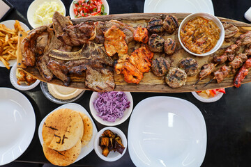 Plates with tasty food on black table, closeup
