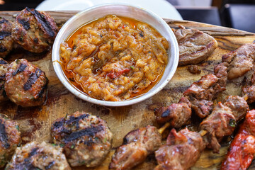 Bowl with tasty food on wooden board, closeup