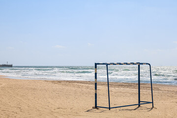 Soccer gate on sand near sea