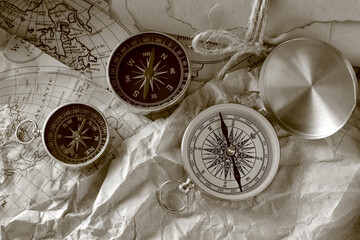 Different vintage compasses on world map