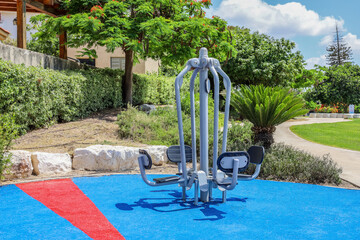 Modern exercise equipment on sport ground in city