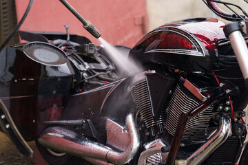 Fototapeta na wymiar Washing a motorcycle engine with a high pressure jet.