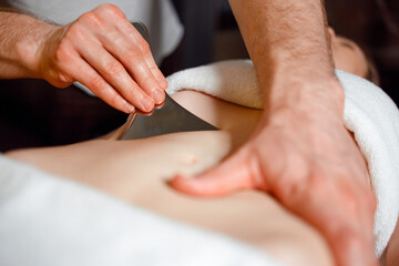 IASTM massage of the female abdominal muscles