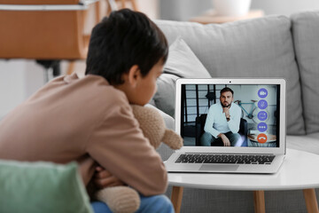 Little boy video chatting with psychologist at home, closeup