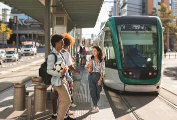 group of students at the train stop to go to university. concept of electric transport, subway,...