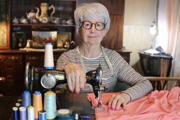Senior woman working with sewing machine 