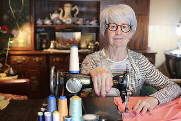Senior woman working with sewing machine 