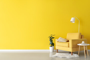 Interior of living room with yellow armchair, table and lamp