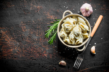Dumplings with beef, garlic cloves and rosemary.