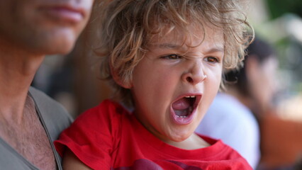 Tired toddler yawning, child yawns