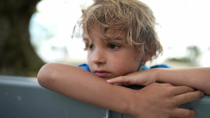 Thoughtful little kid. Pensive contemplative child portrait face close-up