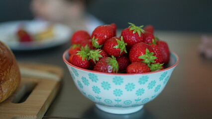 Strawberries inside a bowl, close-up of many berries