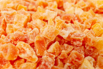 diced candied papaya background. food ingredient. macro photo, shallow depth of field.
