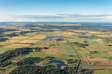 Naklejka premium Aerial view of agricultural fields from above in fly with hot air balloon. Lithuania, Klaipeda city district