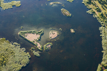 Fototapeta na wymiar A shallow body of water with islands, photographed from above, the bottom is clearly visible