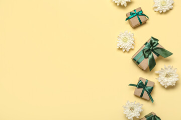Composition with gift boxes and beautiful chrysanthemum flowers on color background