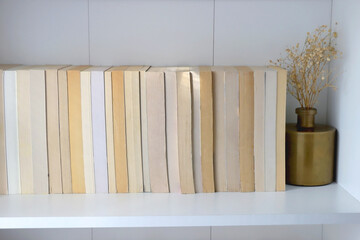 Bookshelf with books turned backwards and minimal decorations.