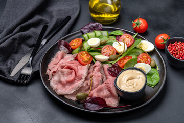 Roast beef with spinach salad and quail eggs healthy lunch keto diet food
