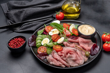 Roast beef with spinach salad and quail eggs healthy lunch keto diet food