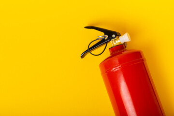Fire extinguisher on a yellow background. Fire protection, home fire extinguisher. home security...