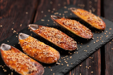 Baked mussels with cheese sesame seeds in shells - asian food