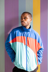 serious african american young man casually dressed in blue sportswear. Black man looking to the...