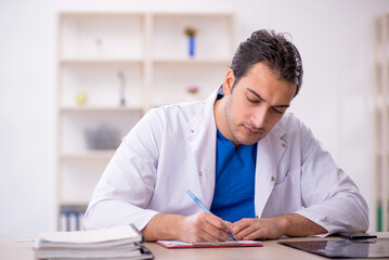 Fototapeta premium Young male doctor working in the clinic