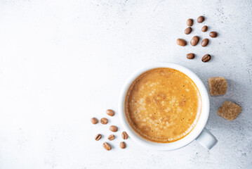 Fresh coffee drink in a white cup on a white background.