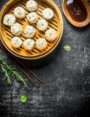 Traditional dish. Dumplings manta with meat in a bamboo steamer.