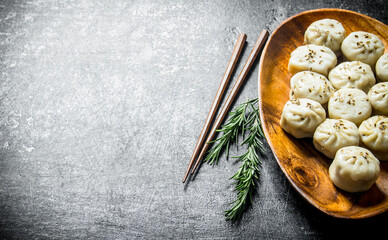 Dumplings manta on a plate with rosemary.